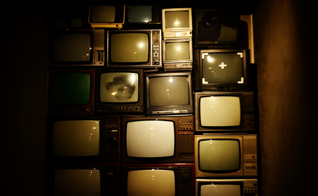 Wall of vintage 80s televisions showing the MTV era home video revolution that changed entertainment