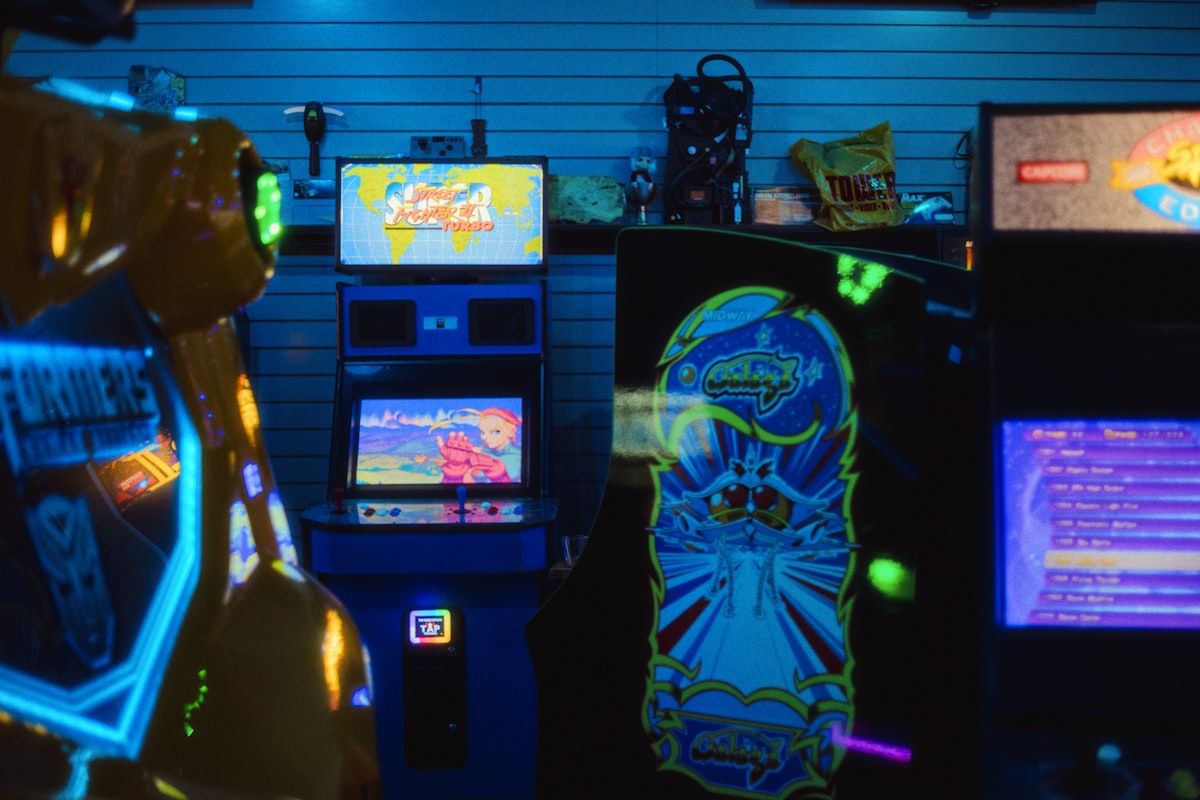 Retro arcade machines glowing in the dark like 90s Nickelodeon game shows Double Dare and GUTS