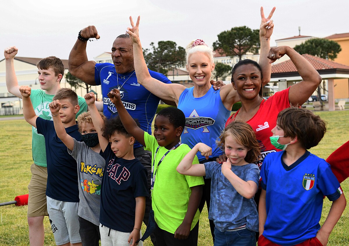 American Gladiators cast members posing with fans at a live event appearance