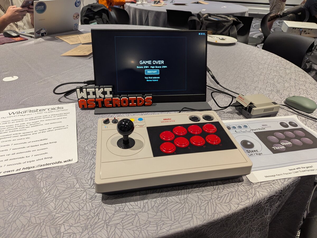 Asteroids arcade game being played at gaming event