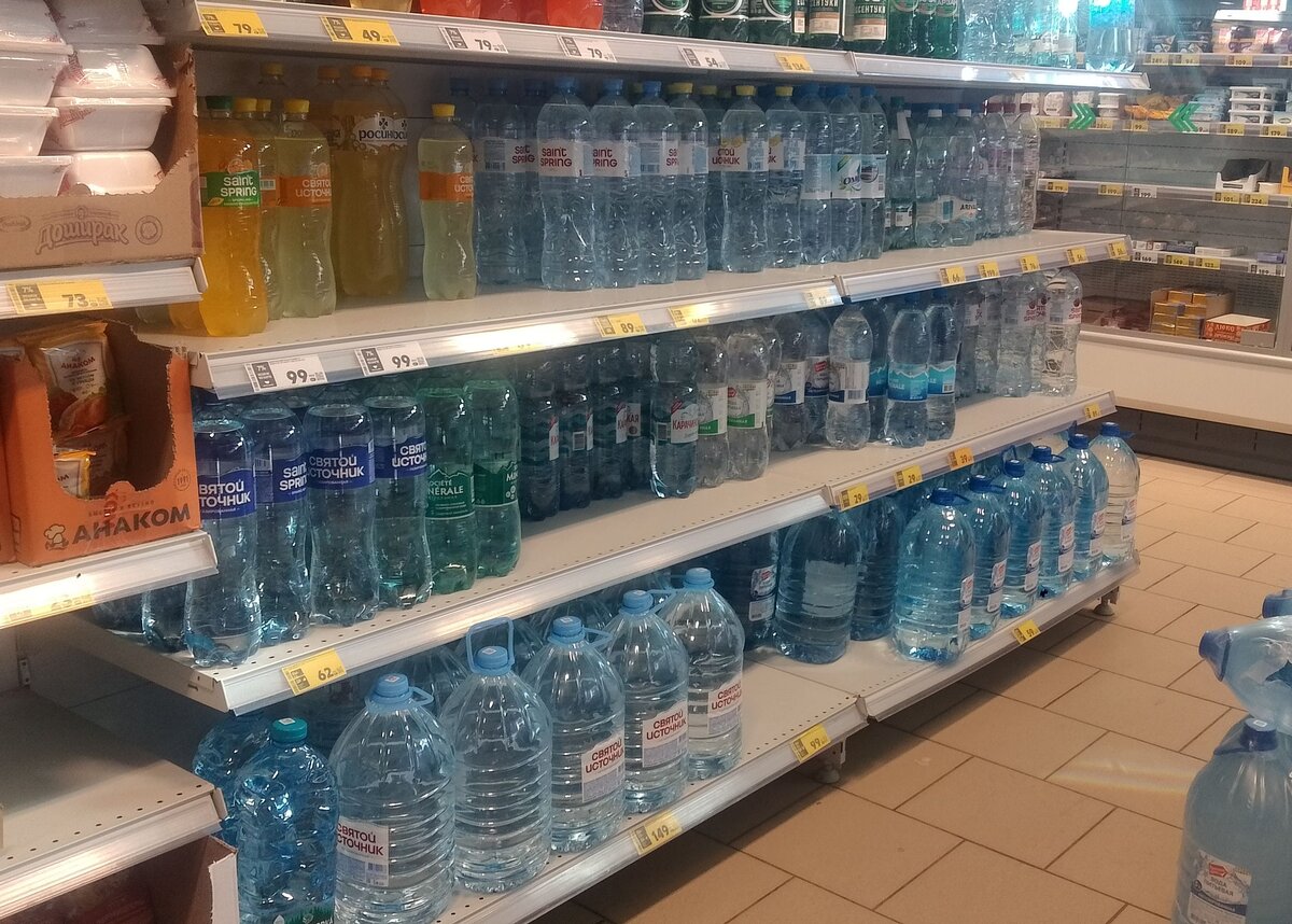 Various bottled water brands on a supermarket shelf
