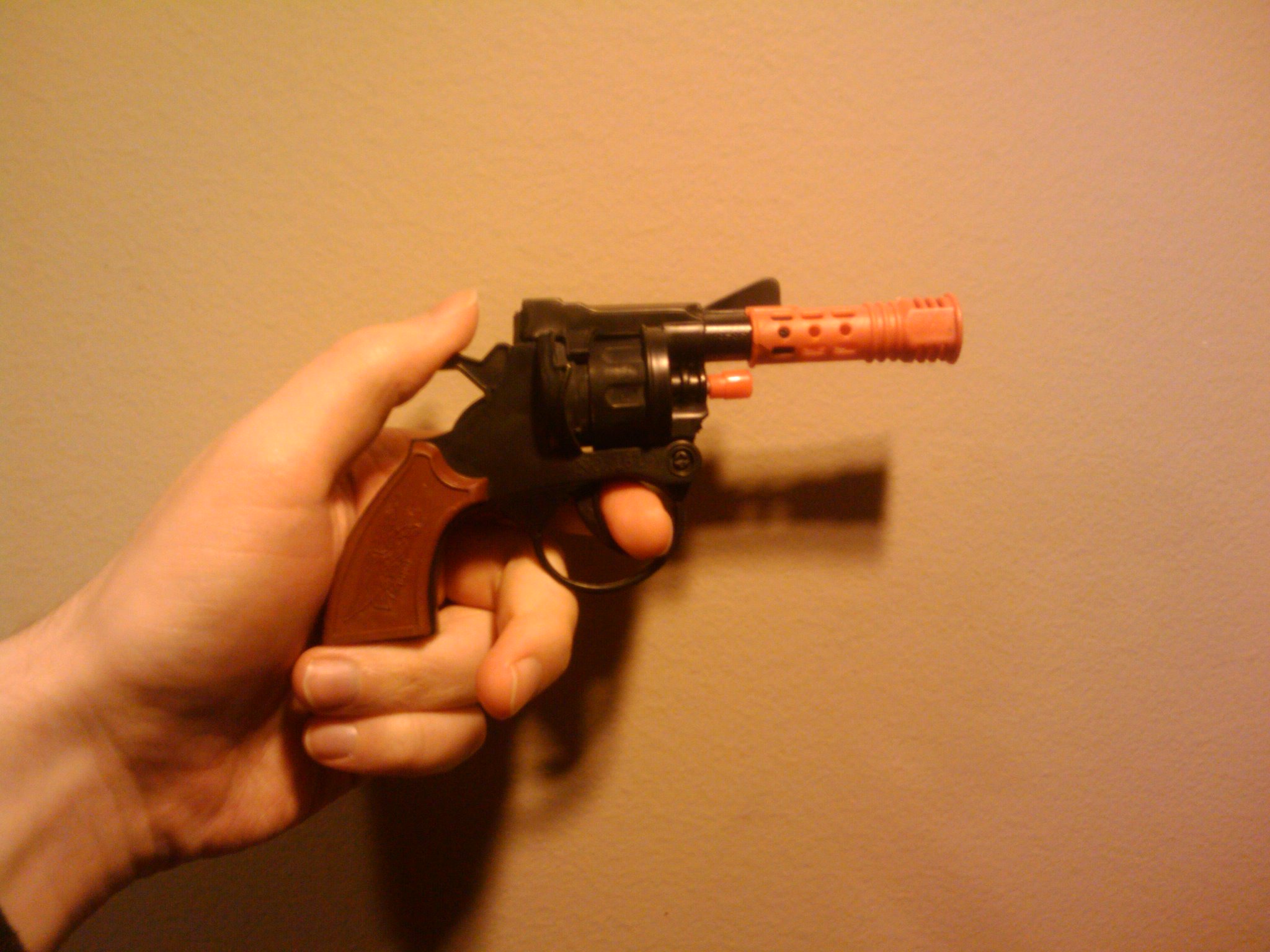 Orange-tipped cap gun toy from the 1980s era