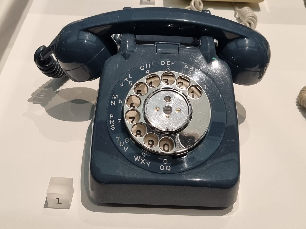 Classic black rotary phone with coiled cord from the 1970s and 80s