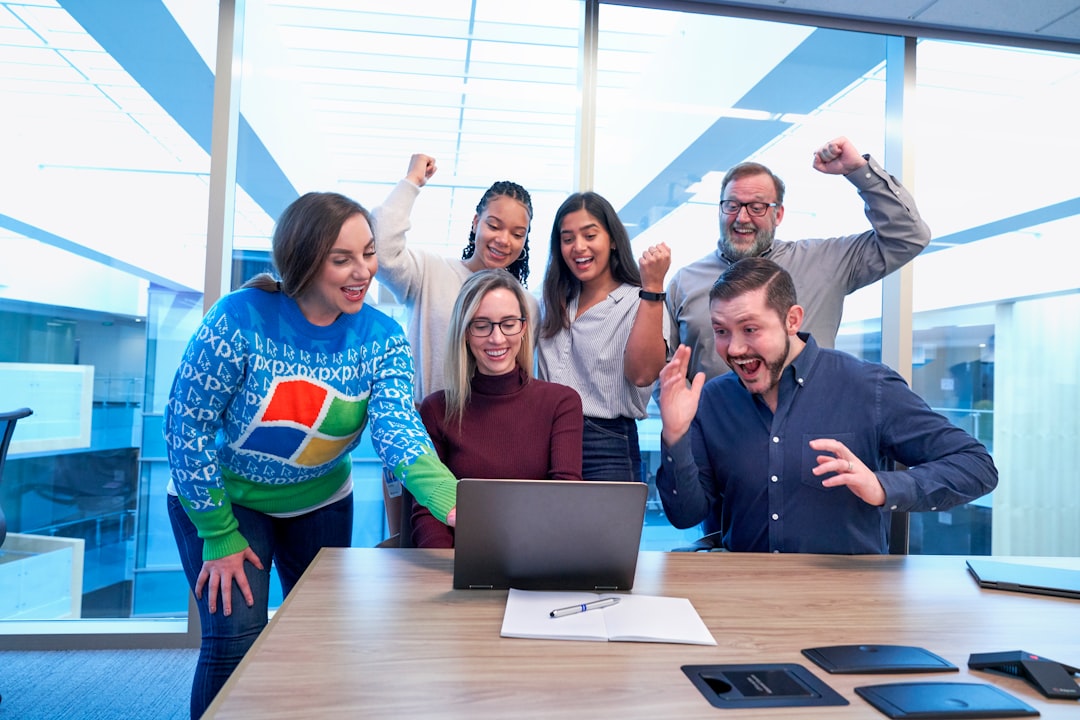 Team collaboration around a laptop demonstrating the collaborative spirit that WikiWikiWeb enabled for programmers worldwide
