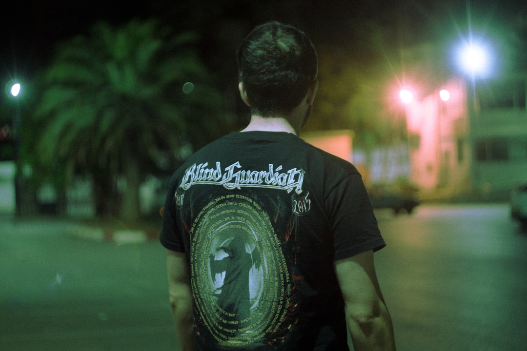 Concert merchandise booth selling band tees at rock show