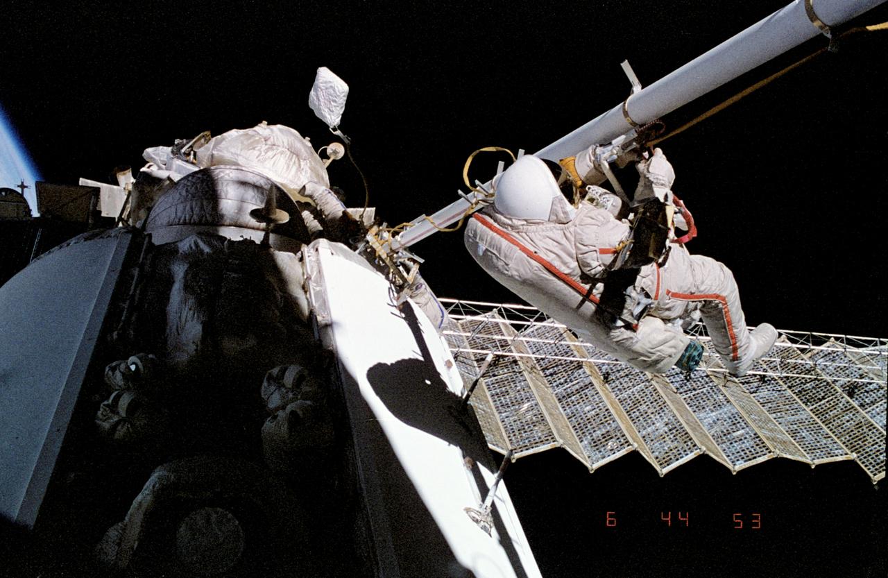 Cosmonaut performing a spacewalk outside the Mir space station during extravehicular activity