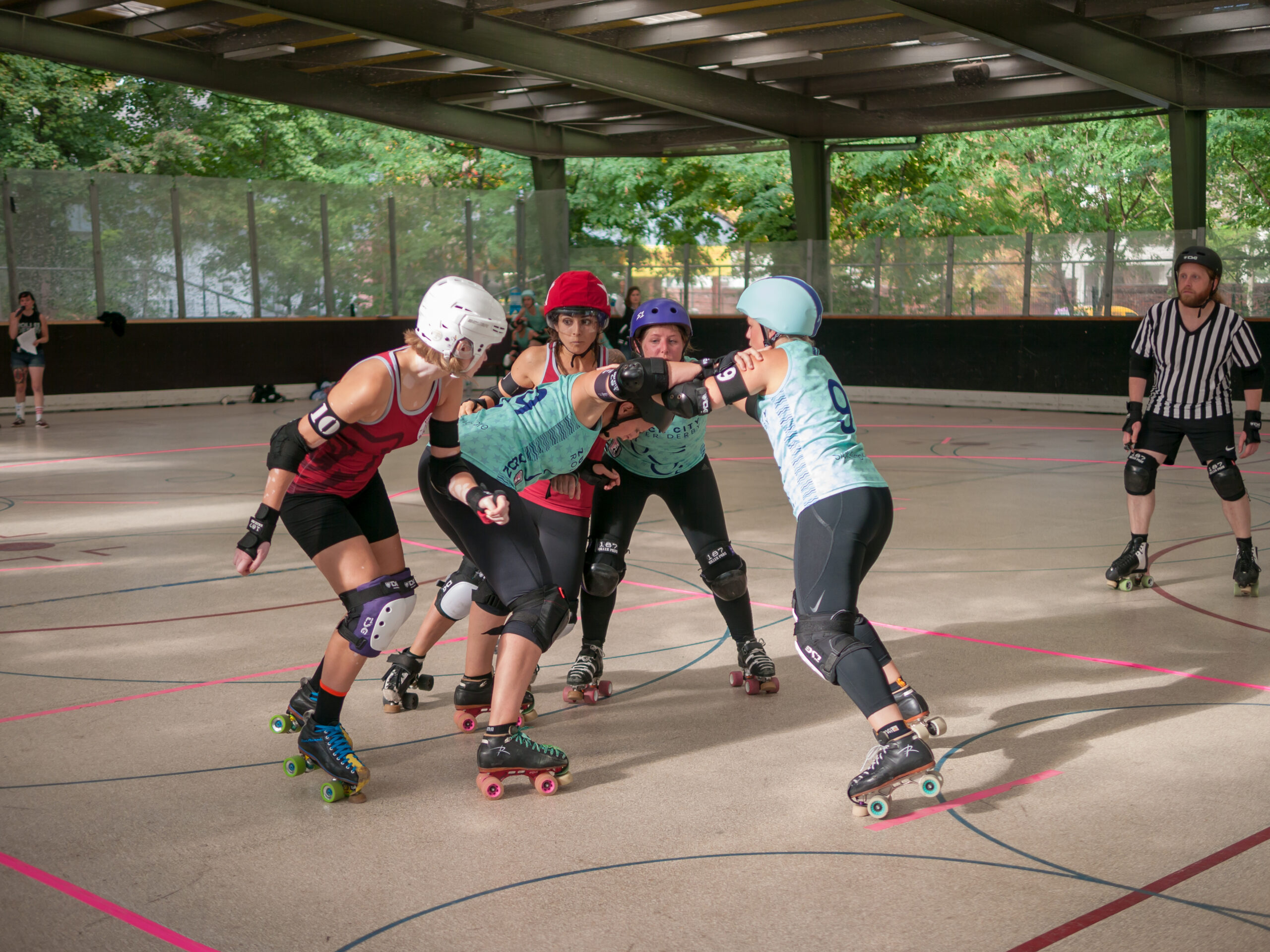 Roller derby players competing in pack formation during bout