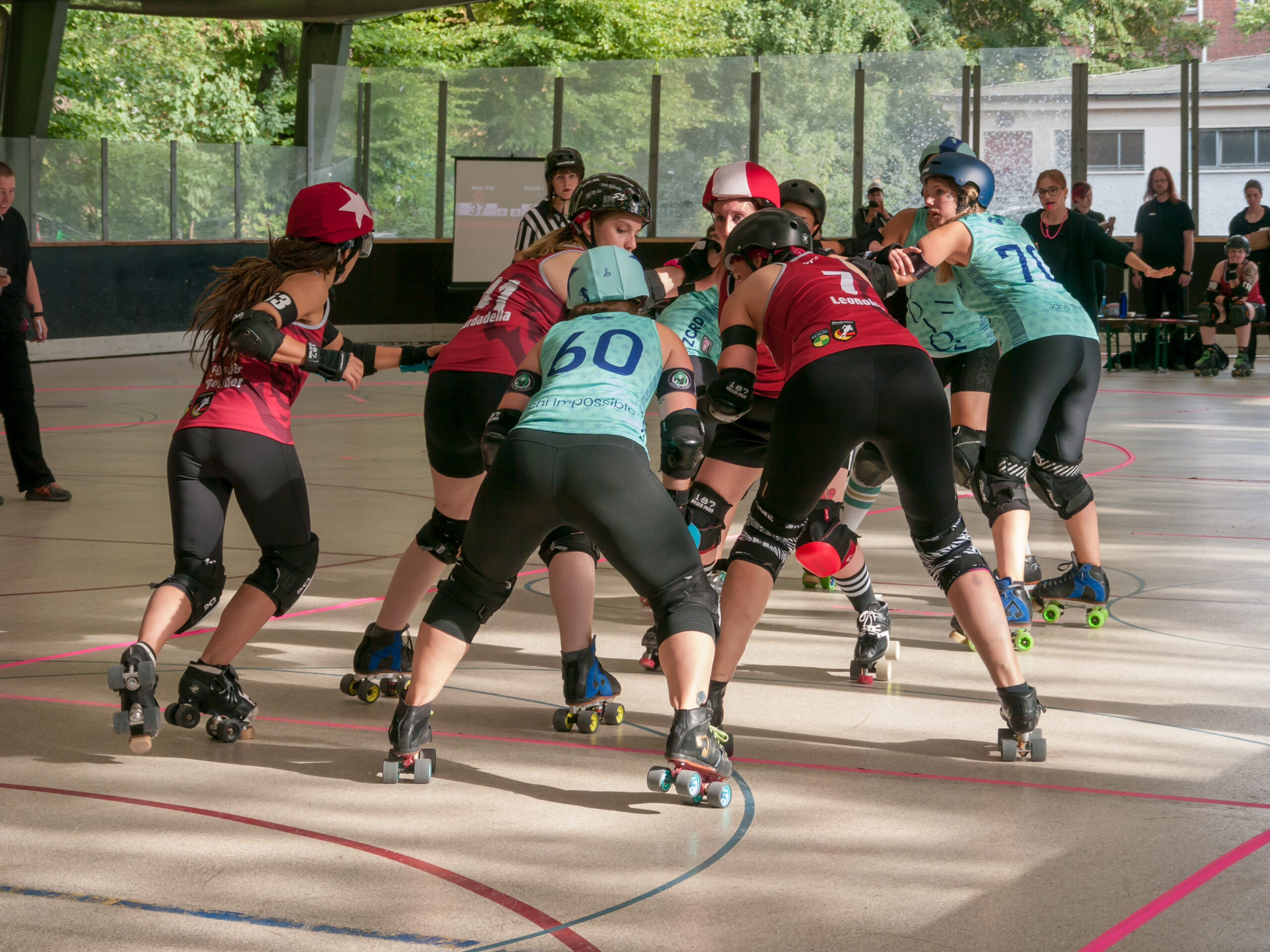 Roller derby skaters battling for position on the track