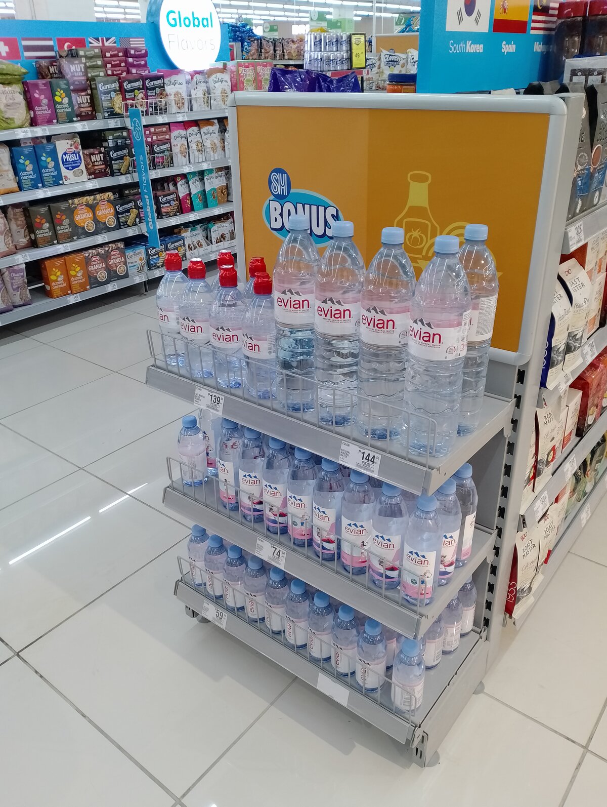 Evian water bottles displayed on supermarket shelf showing bottled water retail presence