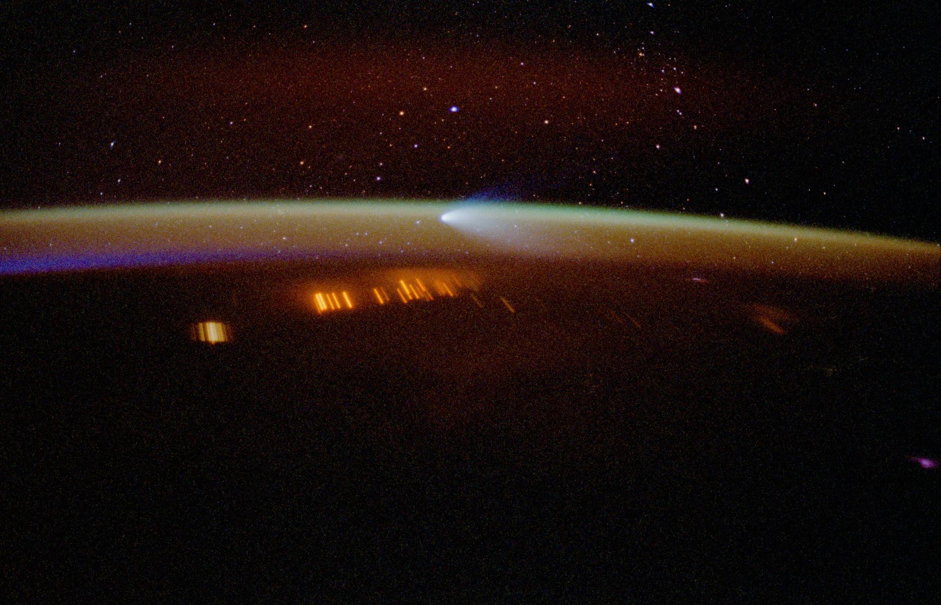 Hale-Bopp comet photographed from space showing brilliant tail against starfield during 1997 closest approach to Earth when Heaven's Gate cult saw it as their sign to transition