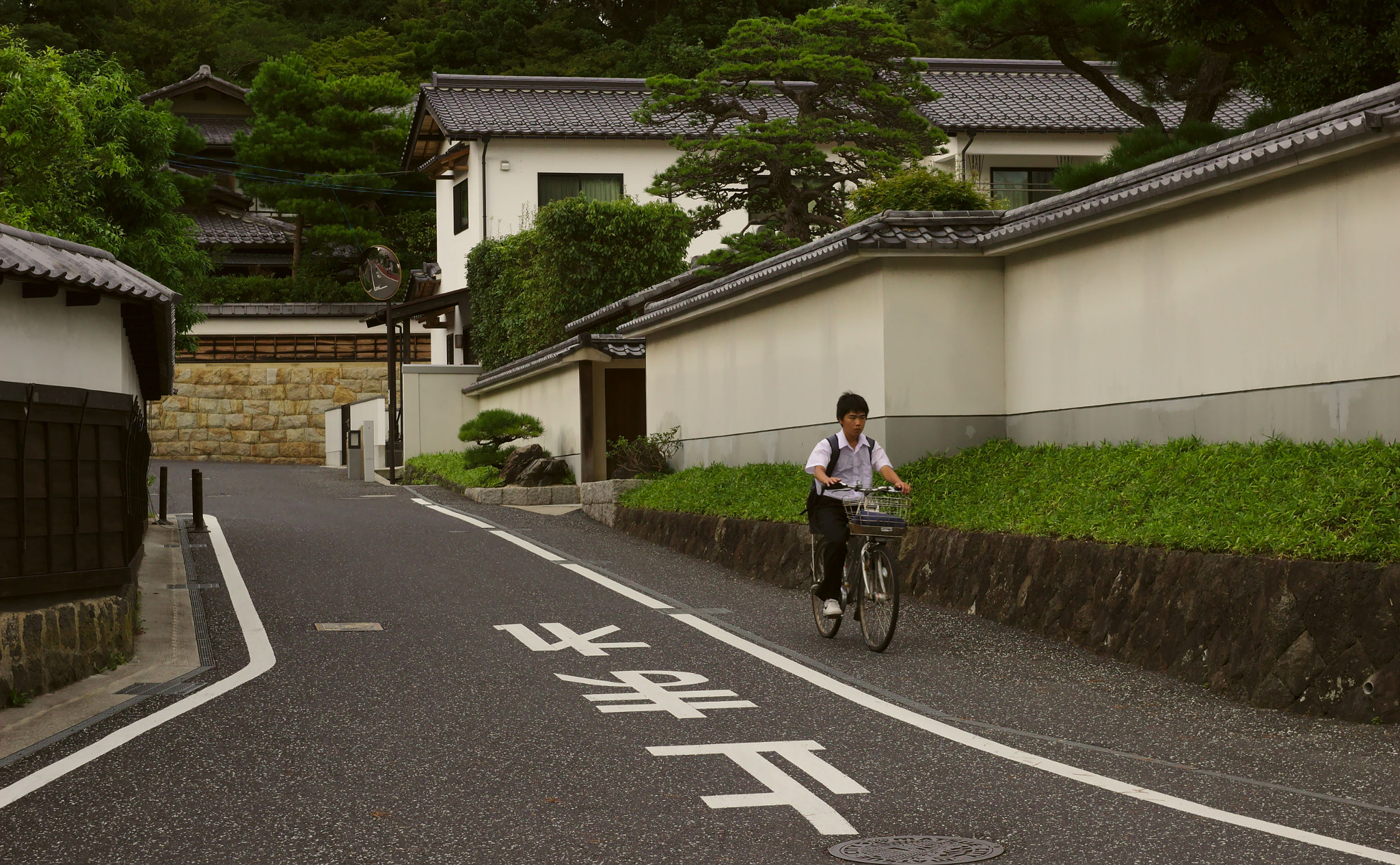 Boy on bicycle exploring neighborhood streets the way Gen X kids did