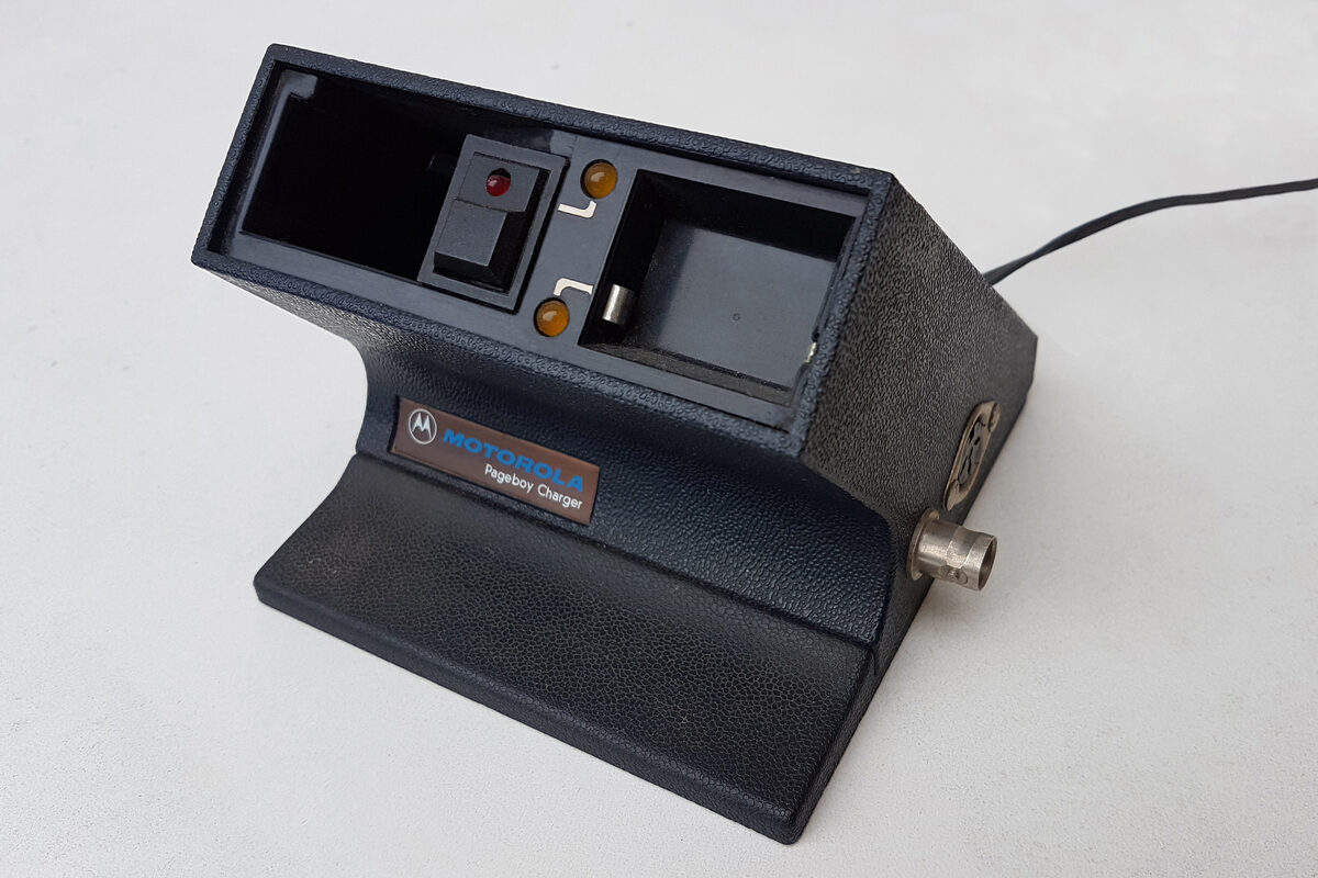 Motorola Pageboy pager with charger showing 90s beeper technology