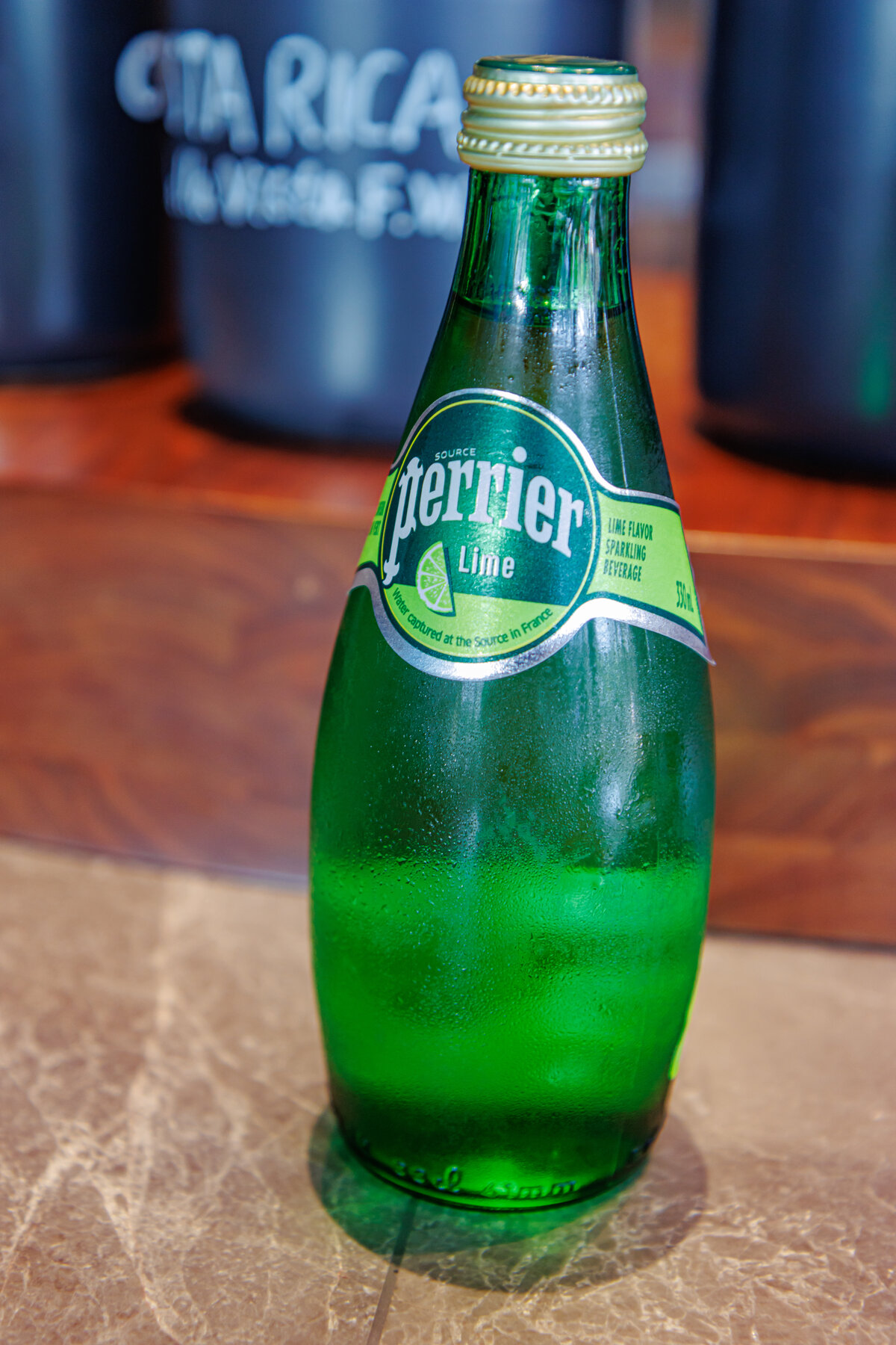 Perrier sparkling mineral water bottle close-up showing premium bottled water branding