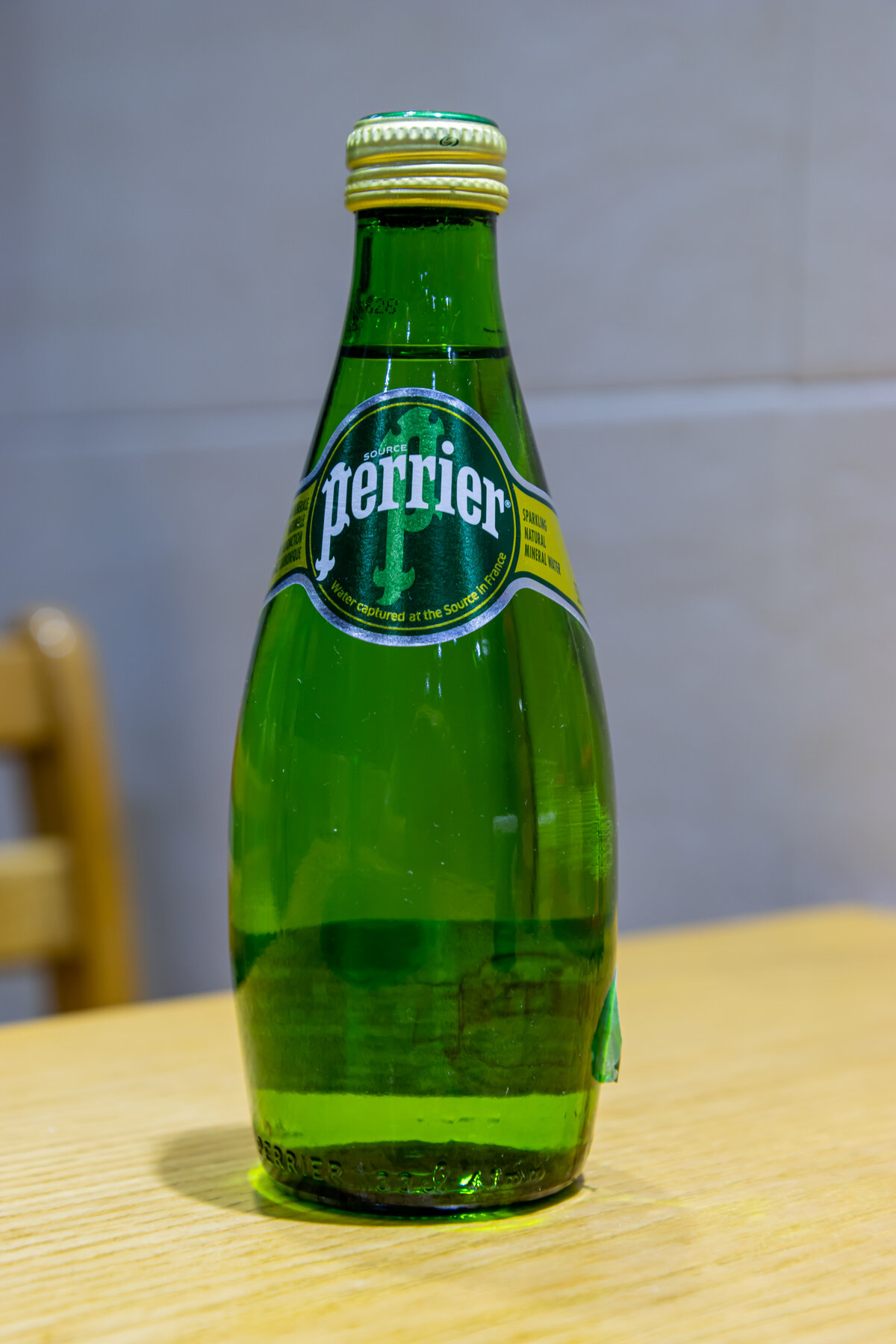 Perrier sparkling water in iconic green glass bottle that started the bottled water revolution