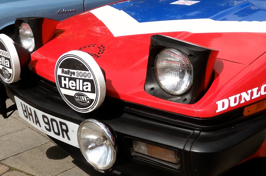 Red Lancia Stratos rally car with pop-up headlights raised open classic 1970s sports car