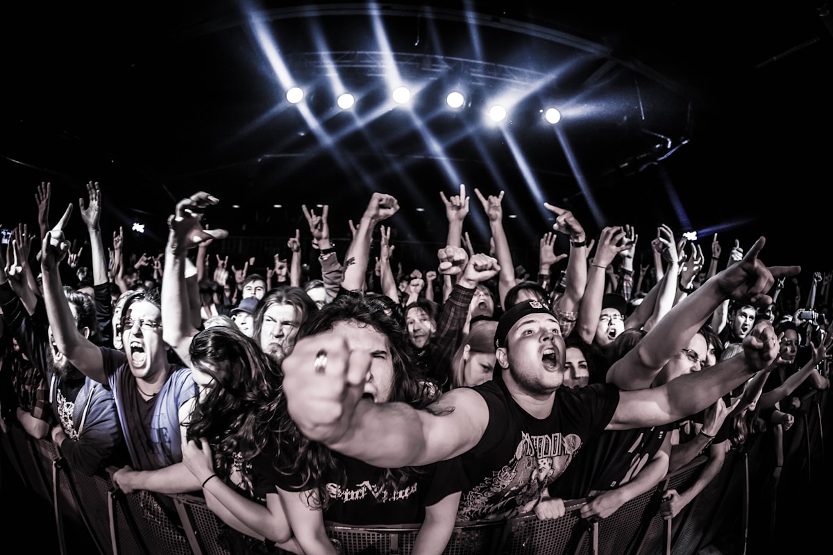 Rock concert crowd at 1980s metal show with hands raised