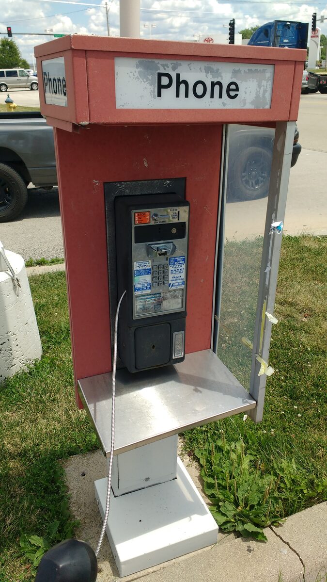 Touch tone payphone booth in public space