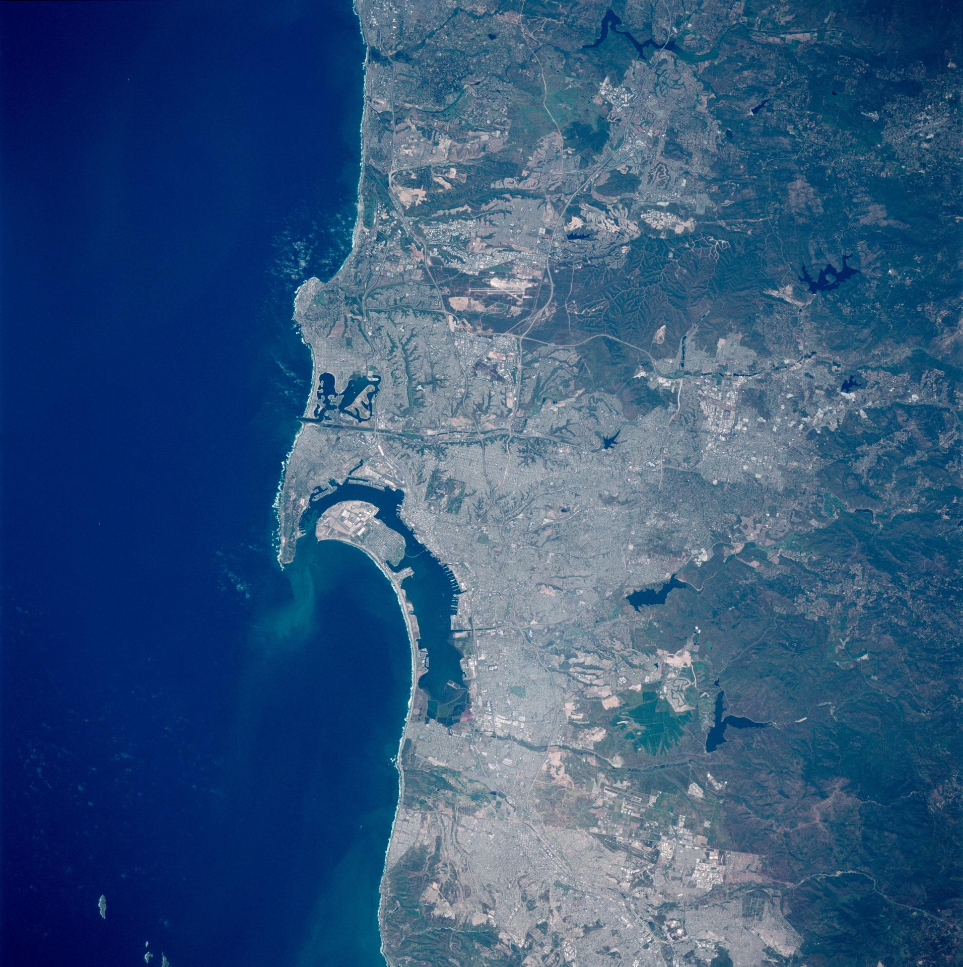 Aerial view of San Diego metropolitan area from space during 1990s showing sprawling suburban developments including Rancho Santa Fe where Heaven's Gate tragedy occurred