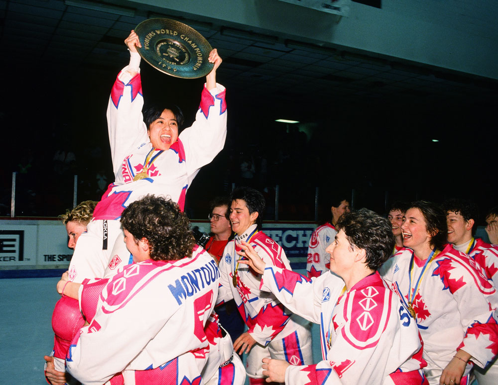 Susie Yuen hoisted by Team Canada teammates holding the 1990 IIHF Women World Championship plate in Ottawa - Credit: Claus Anderson/HHOF