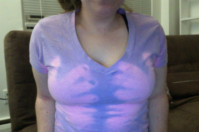 Person wearing a purple Hypercolor shirt showing the color-changing effect from body heat