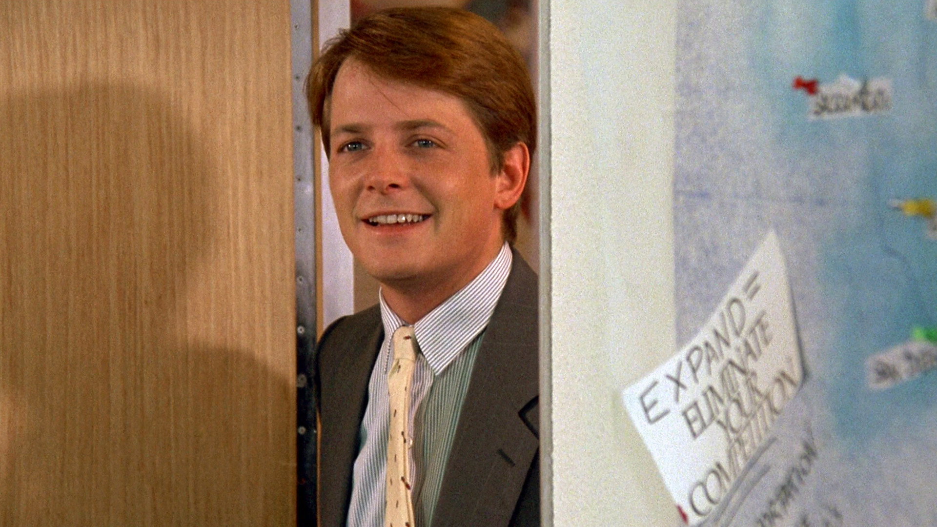 Michael J. Fox in The Secret of My Success wearing business attire