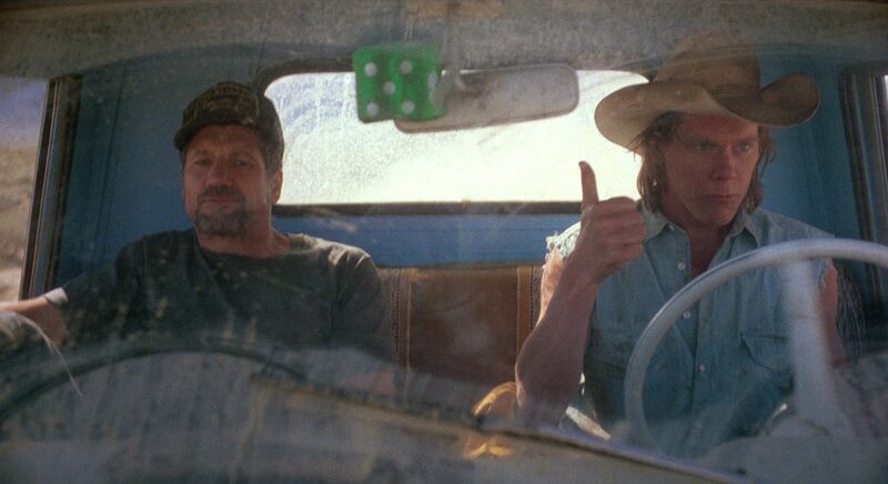 Kevin Bacon and Fred Ward as Val and Earl in Tremors 1990 desert scene