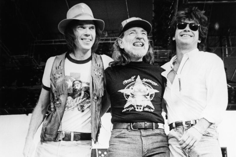 Young Willie Nelson and John Mellencamp performing at Farm Aid