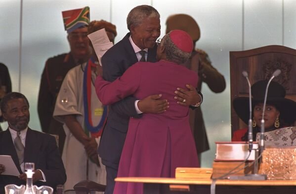 Nelson Mandela embracing Archbishop Desmond Tutu after the swearing-in ceremony