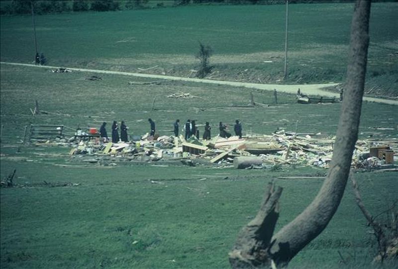 Search and recovery teams walking through May 31 1985 tornado debris