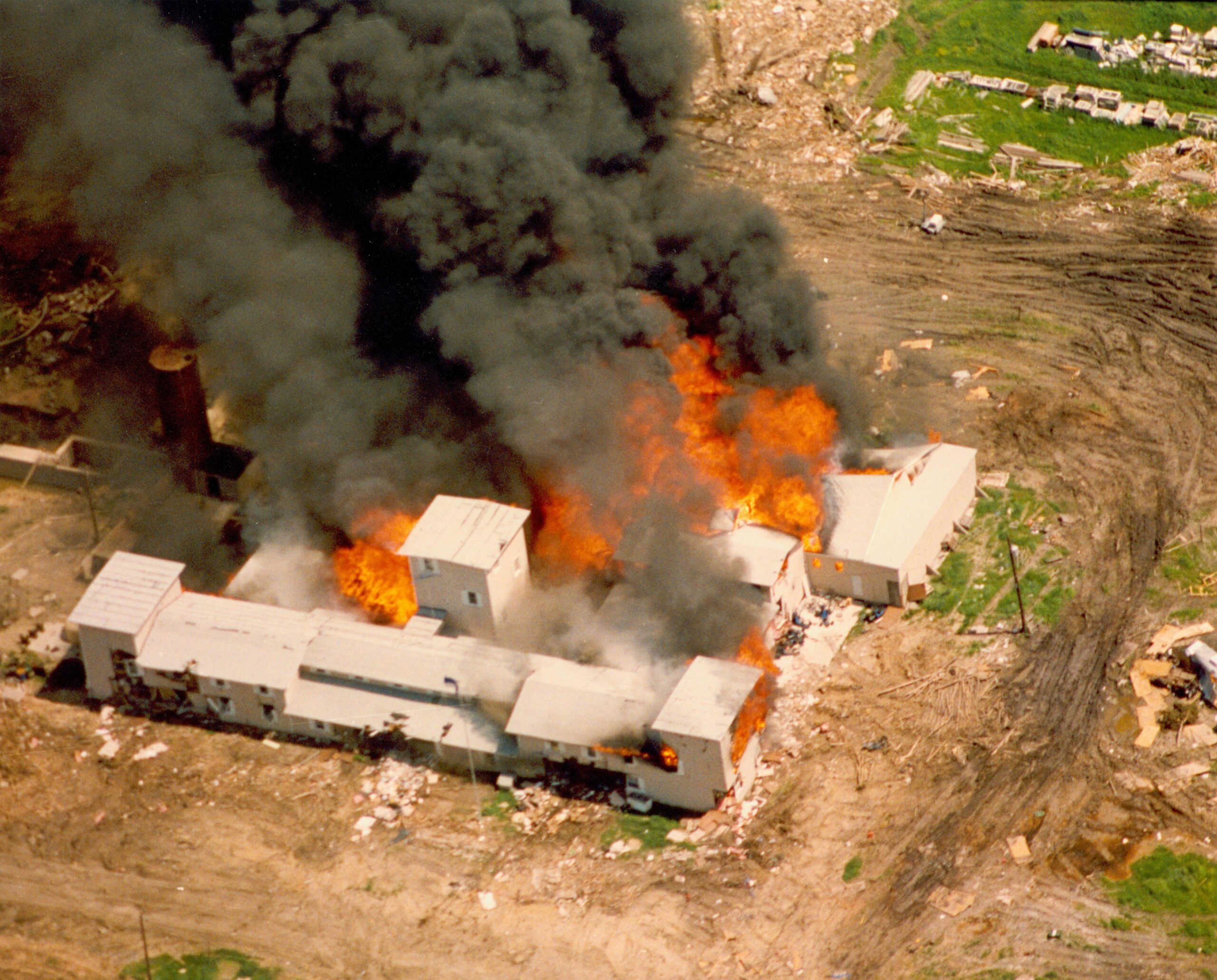 Aerial FBI photograph Branch Davidian compound near Waco Texas in flames April 19 1993