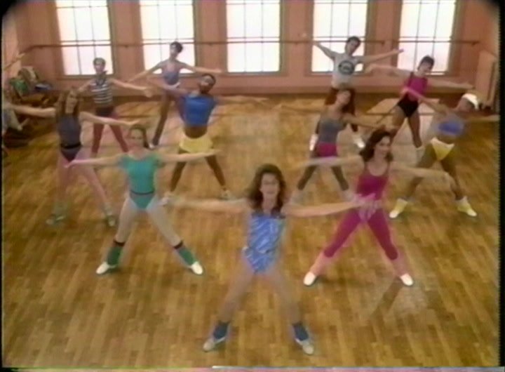 80s aerobics class group spreading arms in Jane Fonda New Workout 1986