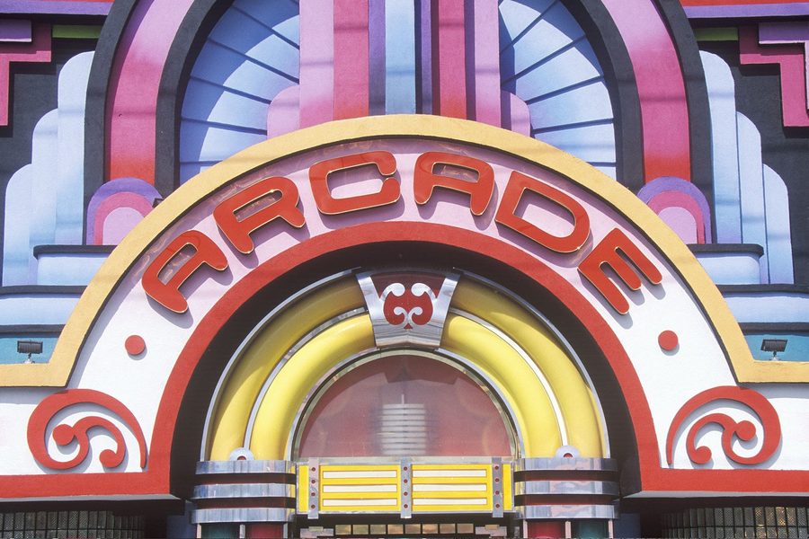 80s arcade entrance with bright Art Deco neon marquee