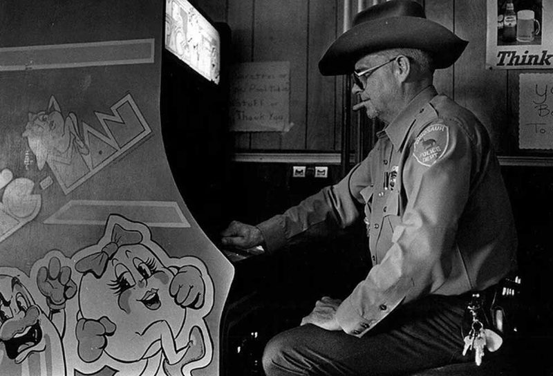 Player chasing a high score on an 80s arcade game cabinet