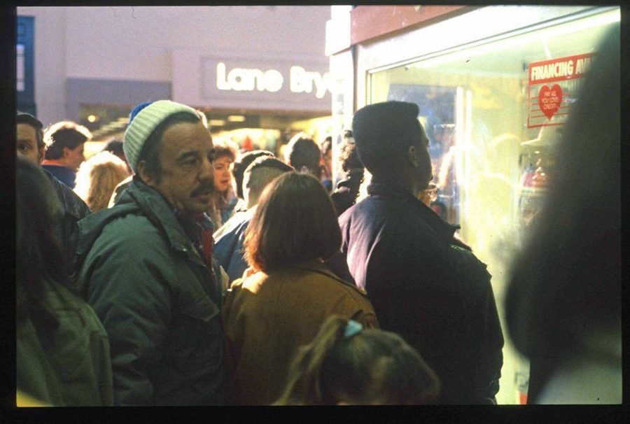1980s mall holiday shopping crowd outside Lane Bryant with Pay As You Love Credit financing sign