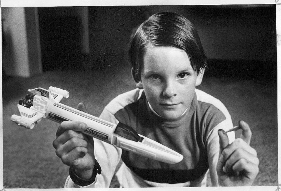Boy holding Mattel Battlestar Galactica Colonial Viper missile launcher toy from 1978