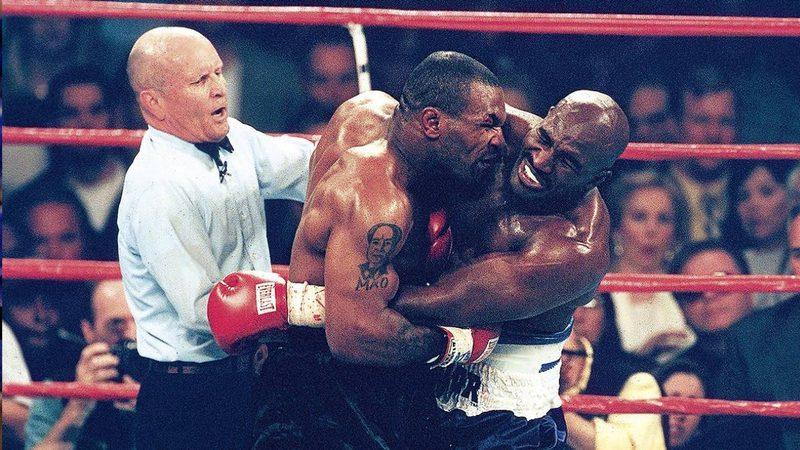 Referee Mills Lane steps in after Mike Tyson bites Evander Holyfield in the bite fight