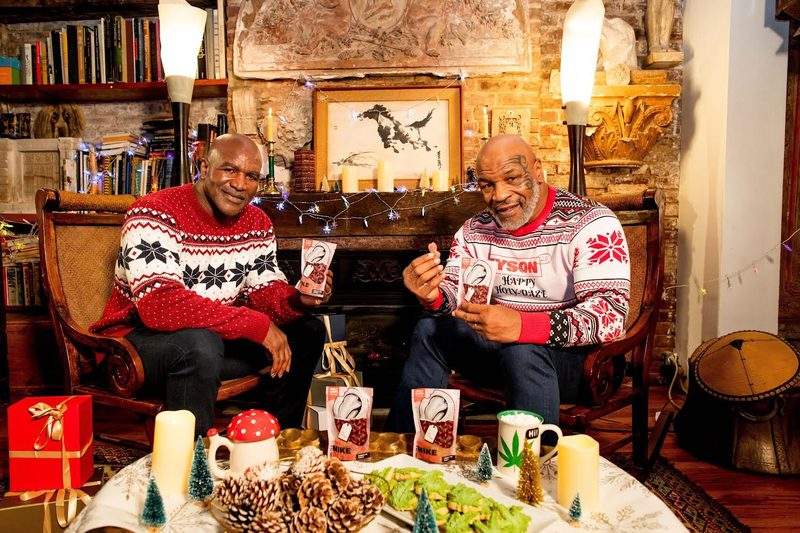 Mike Tyson and Evander Holyfield friends posing with ear-shaped edibles years after the bite fight