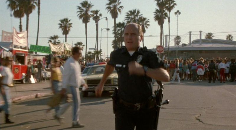 LAPD officer at Venice Beach boardwalk in Colors 1988 chase sequence