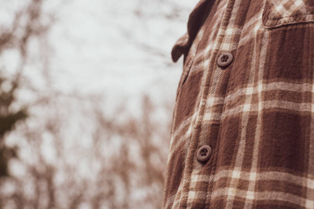 closeup of buttons on man's brown flannel coat - plaid flannel stock pictures, royalty-free photos & images