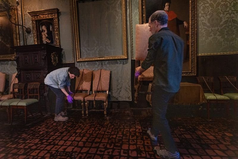 Conservators restoring an empty frame from the Gardner Museum heist