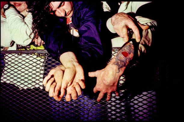 Member of the audience at a concert by American rock group Nirvana, shows off a tattoo, Belfast, 1992.