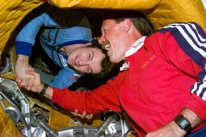 Commander Hoot Gibson and cosmonaut Vladimir Dezhurov shake hands during the first Shuttle-Mir docking 1995