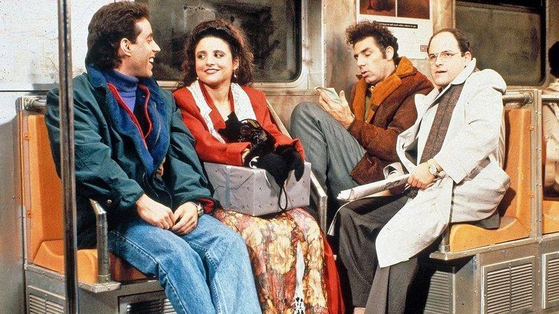 Jerry and Elaine Benes sitting on the couch in Seinfeld