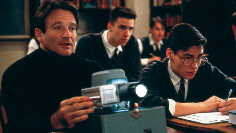 John Keating with a film projector in Dead Poets Society classroom