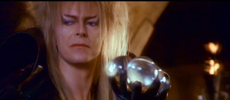 David Bowie as Jareth the Goblin King holding a crystal ball in Labyrinth 1986