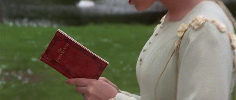 Sarah holding the red Labyrinth book in the 1986 film