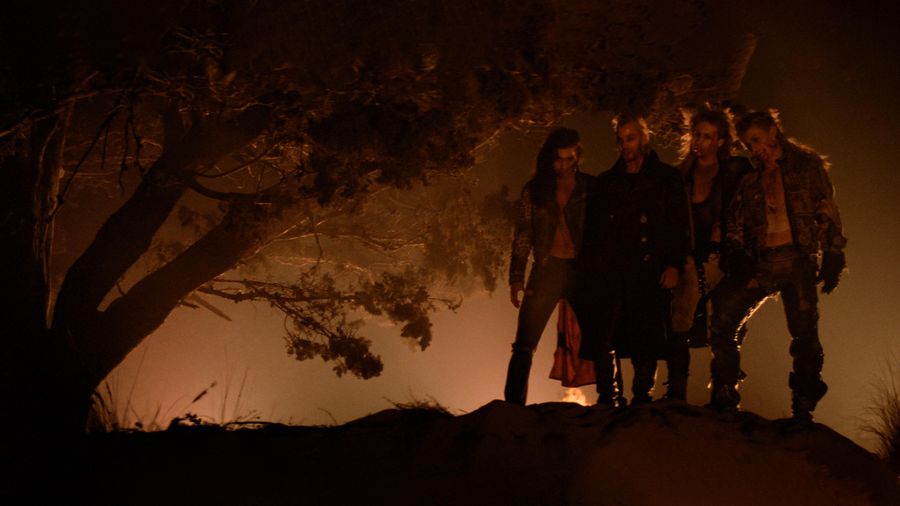 The Lost Boys vampires on a Santa Carla hillside at night with bonfire and motorcycles