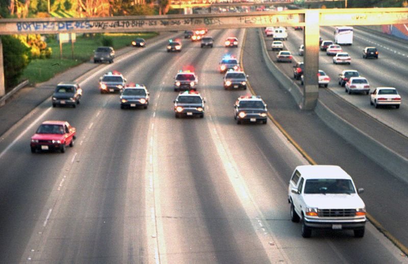 LAPD and CHP cruisers in line pursuing the white Ford Bronco during the OJ Simpson chase on the 405 freeway
