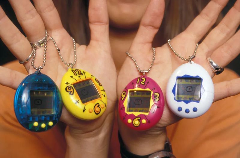 Original Tamagotchi 1997 devices in blue yellow pink and white different colors