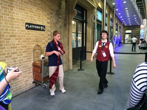Platform 9 3/4 sign and luggage trolley at King's Cross Station in London